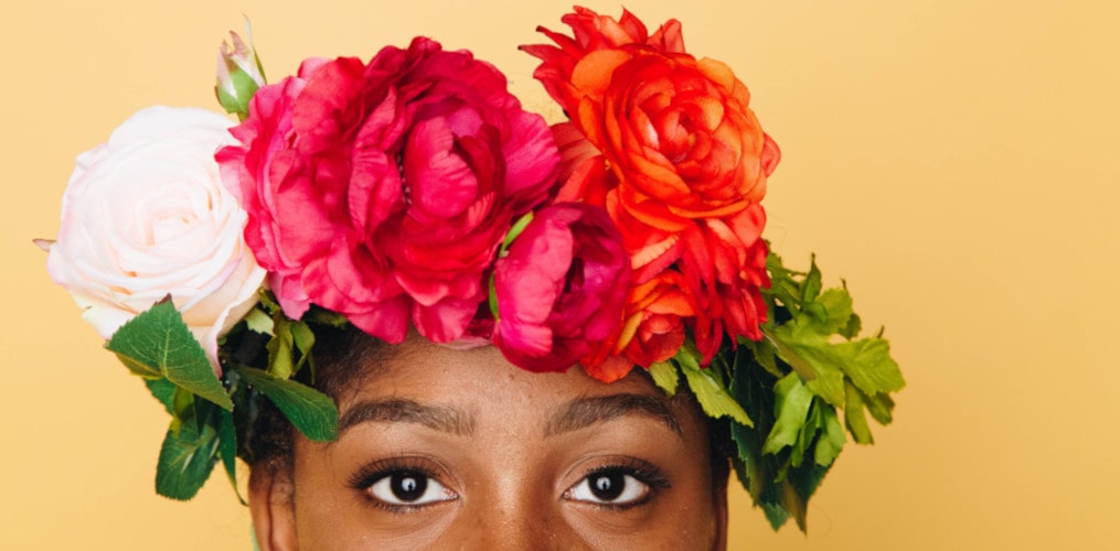Image of a black girl with flowers in line with Black History Month theme