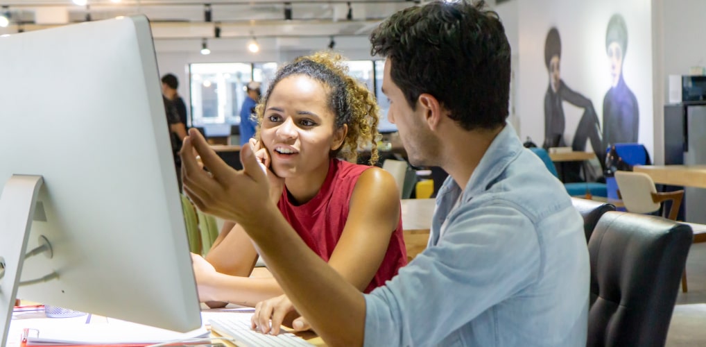 Two employees discussing ways to take action based on collected employee feedback